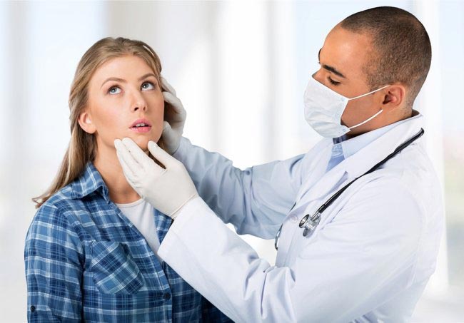 doctor checking female patient