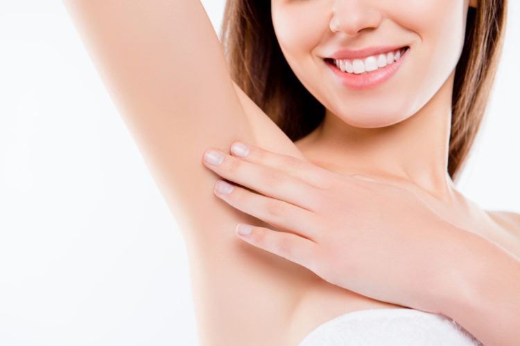 Sensual sensitive pampering concept. Cropped close up photo of charming smiling beautiful lady tenderly gently touching her flawless soft skin on the armpit isolated on white background