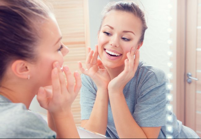 Young women looking into a mirror