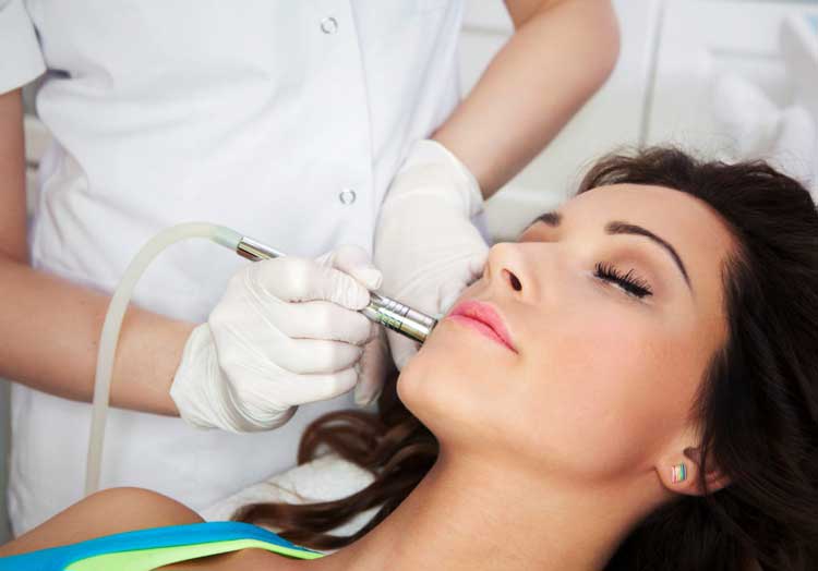 Woman getting laser face treatment in medical spa