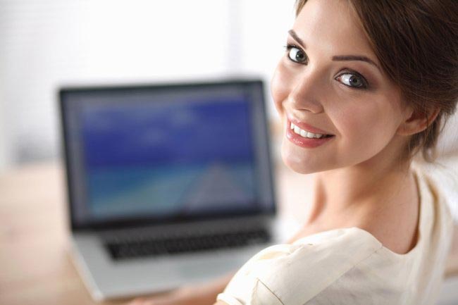 Beautiful woman sitting in front of laptop