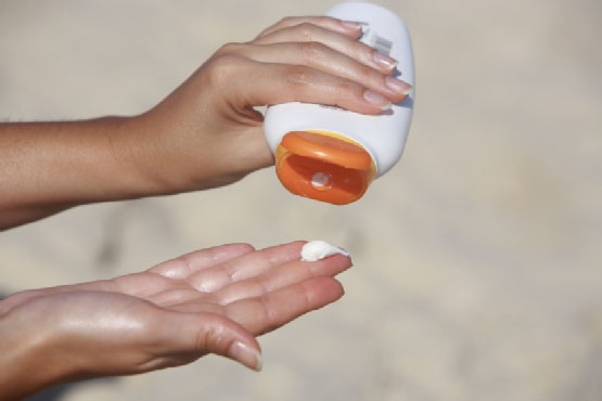 Woman applying sunscreen