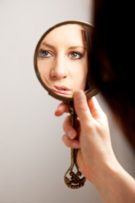 Woman looking in the mirror