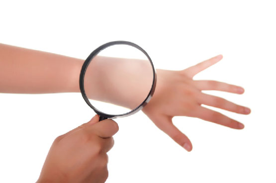 Magnifying glass on hand