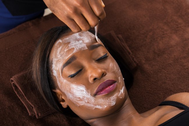 Applying Chemical Peel on a women face