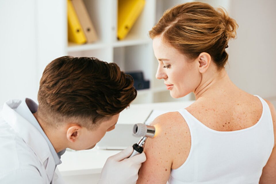 A doctor examining a person's back