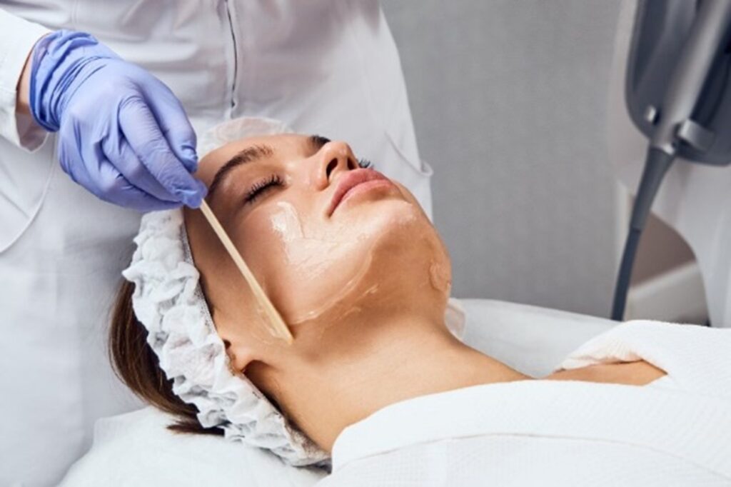 A woman receiving a chemical peel from a professional by Swinyer Woseth Dermatology
