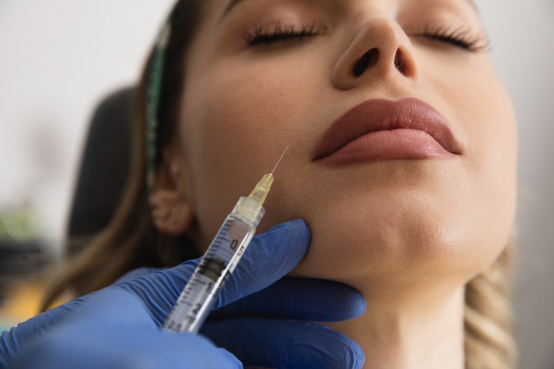 A woman receiving lip filler by Swinyer Woseth Dermatology