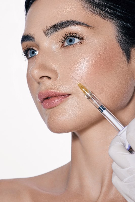 A woman getting dermal filler by Swinyer Woseth Dermatology