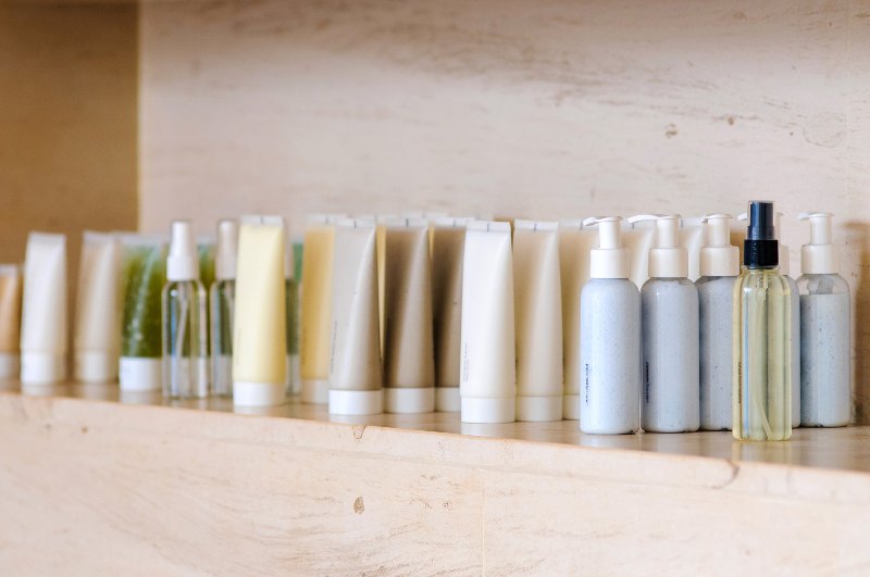 Different skin care products lined on a shelf by Swinyer Woseth Dermatology