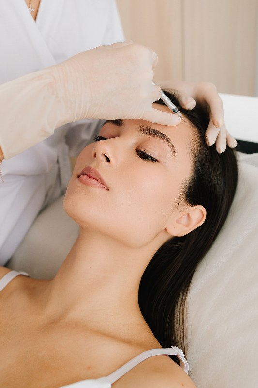A woman receiving neuromodulators by Swinyer Woseth Dermatology