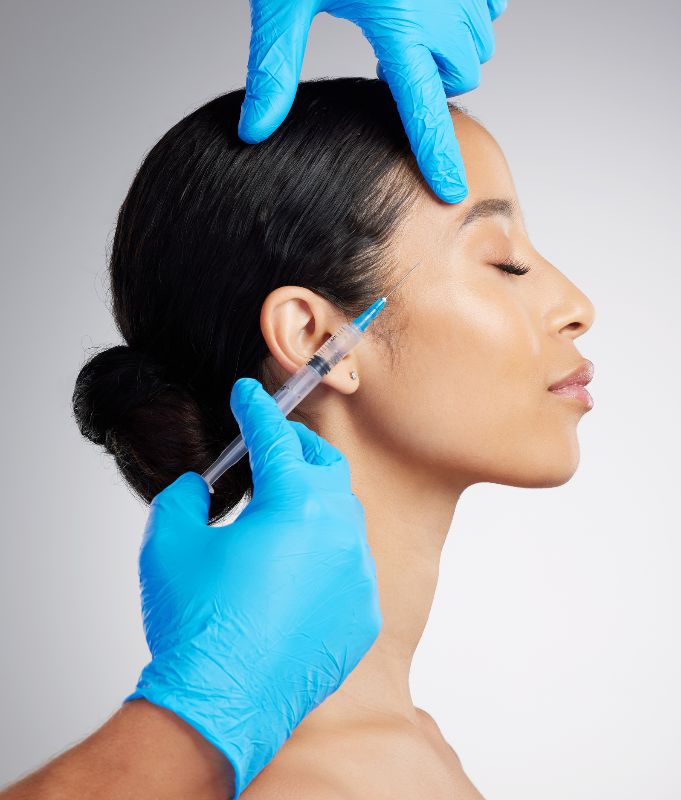The side profile of a young woman receiving Botox injections by Swinyer Woseth Dermatology